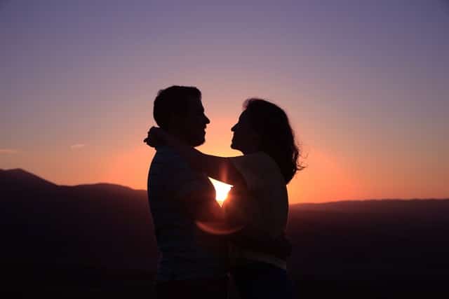 image of a couple holding each other in sunset