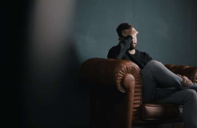 image of man sitting on sofa during couples therapy