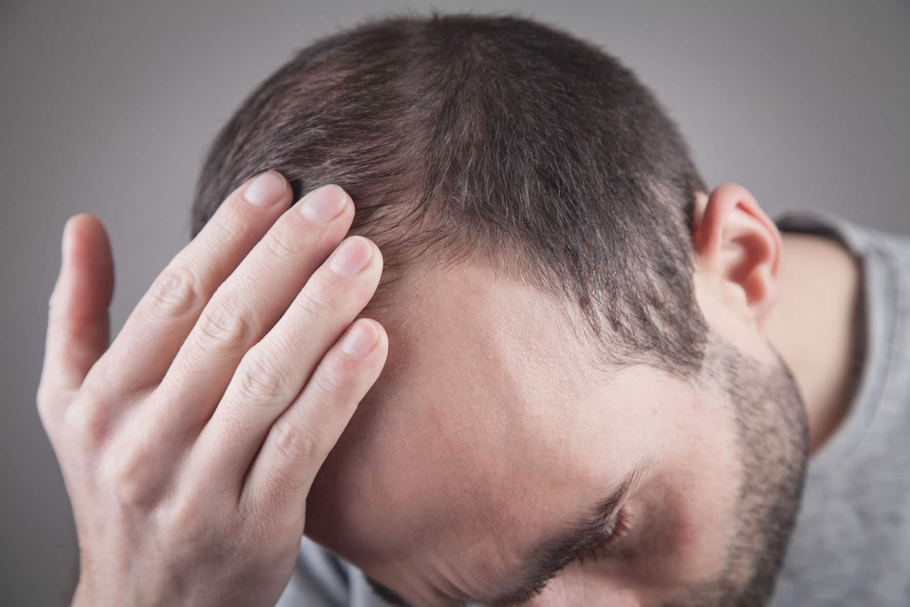 man looking at damaged hair