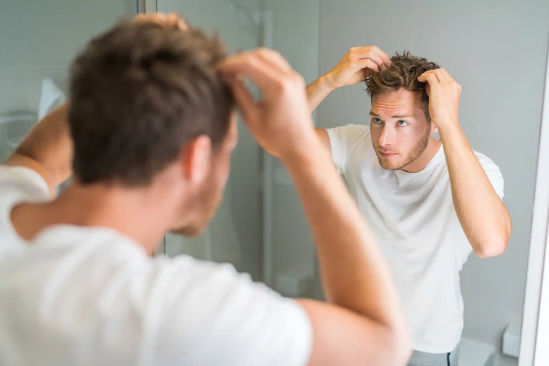 man looking at hair loss