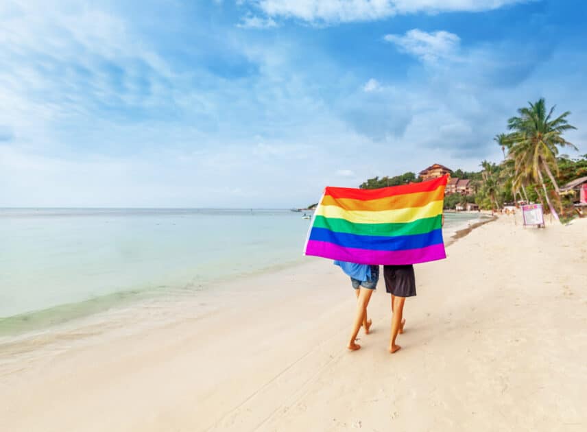 LGBT flag in beach and two women 