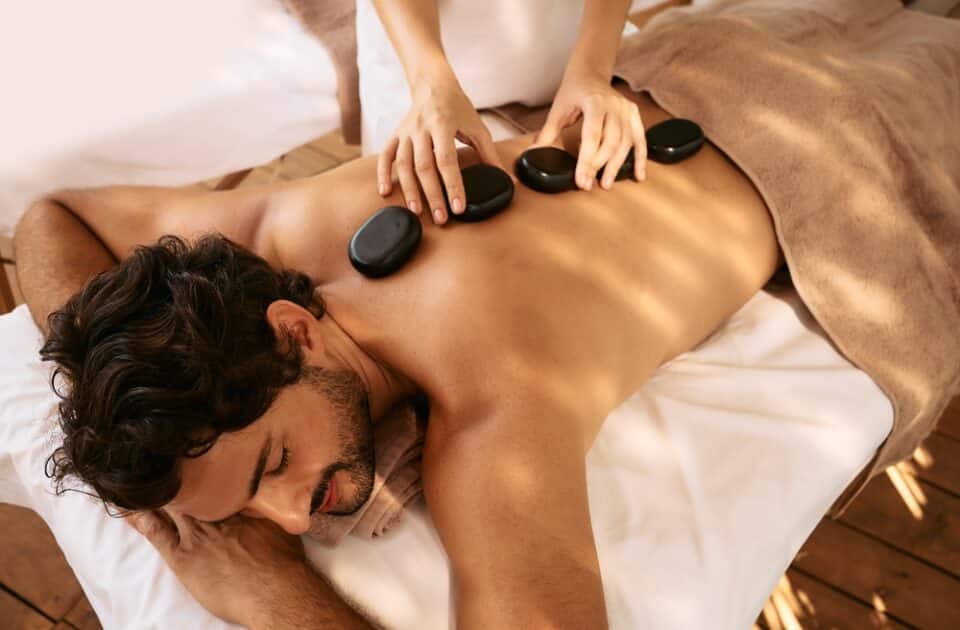 man having hot stone massage
