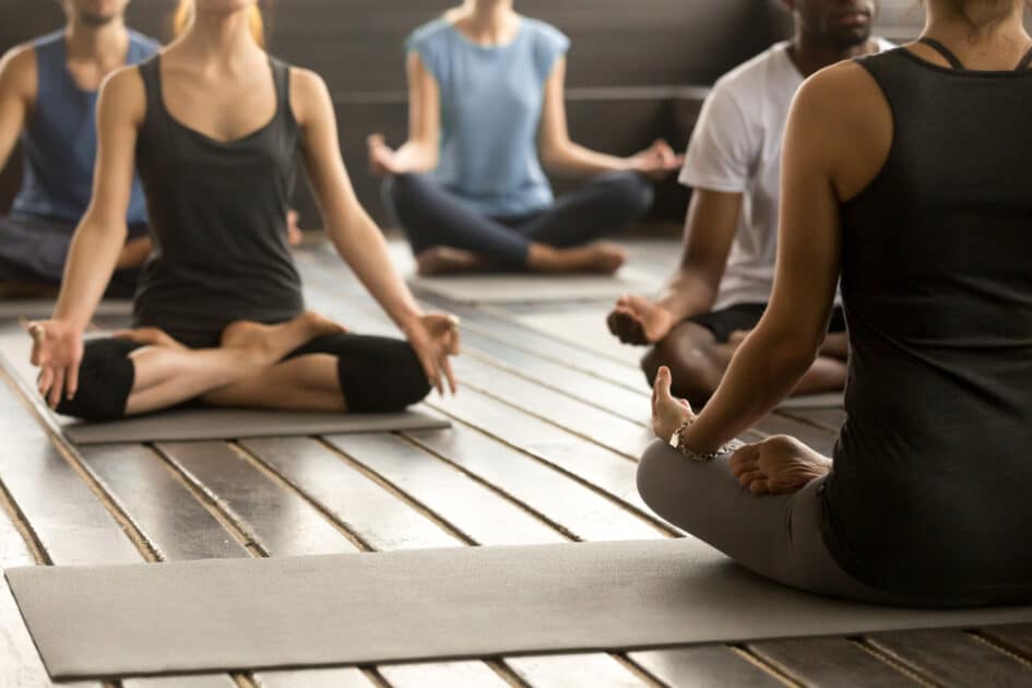 a bunch of people meditating yoga