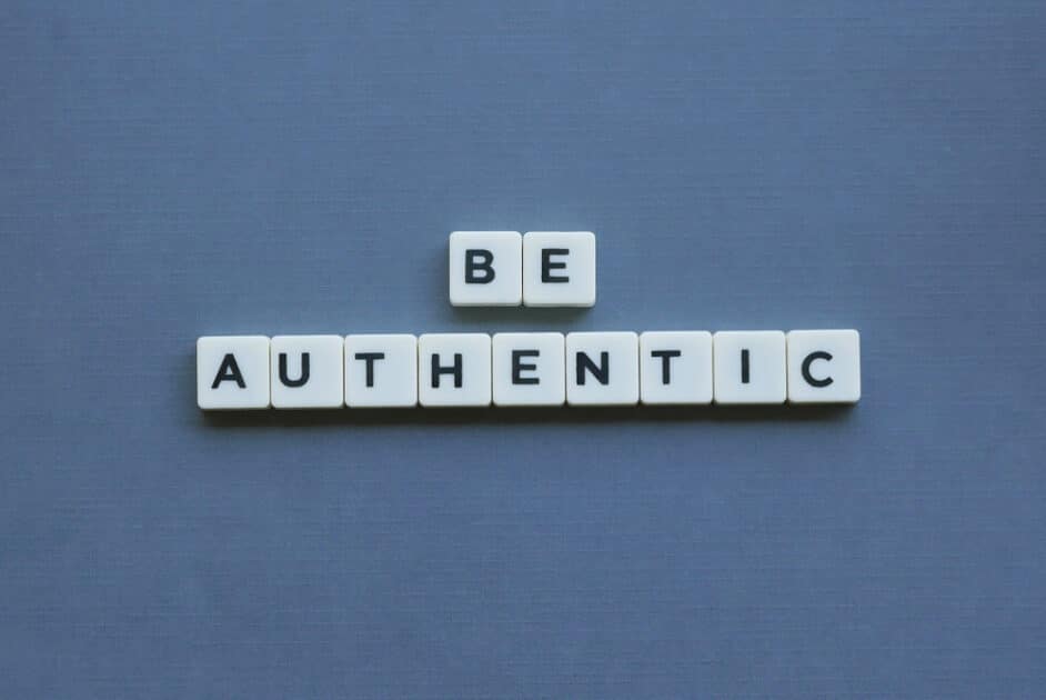 Word "Be Authentic" with square letters on a gray backdrop.
