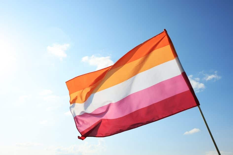 (Lesbian Pride Flag)Bright lesbian flag fluttering against blue sky