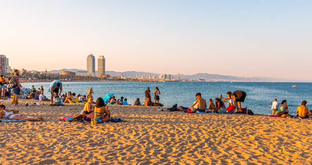 image of a beach in Barcelona with many people enjoying the sun and summer