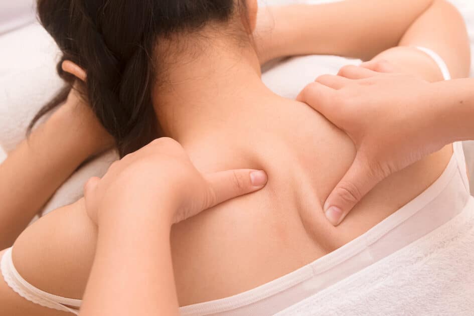 White towel and woman having deep massage to Improve Posture
