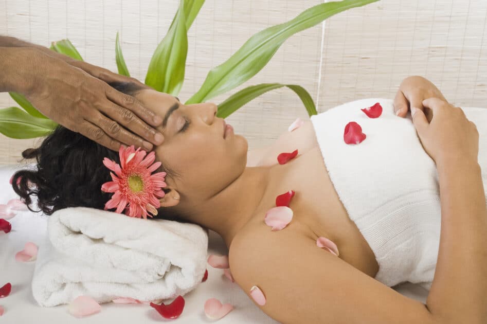 a woman getting indian head massage in spa