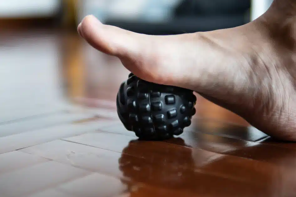 Step your foot onto a massage ball to treat heel discomfort or plantar fasciitis.