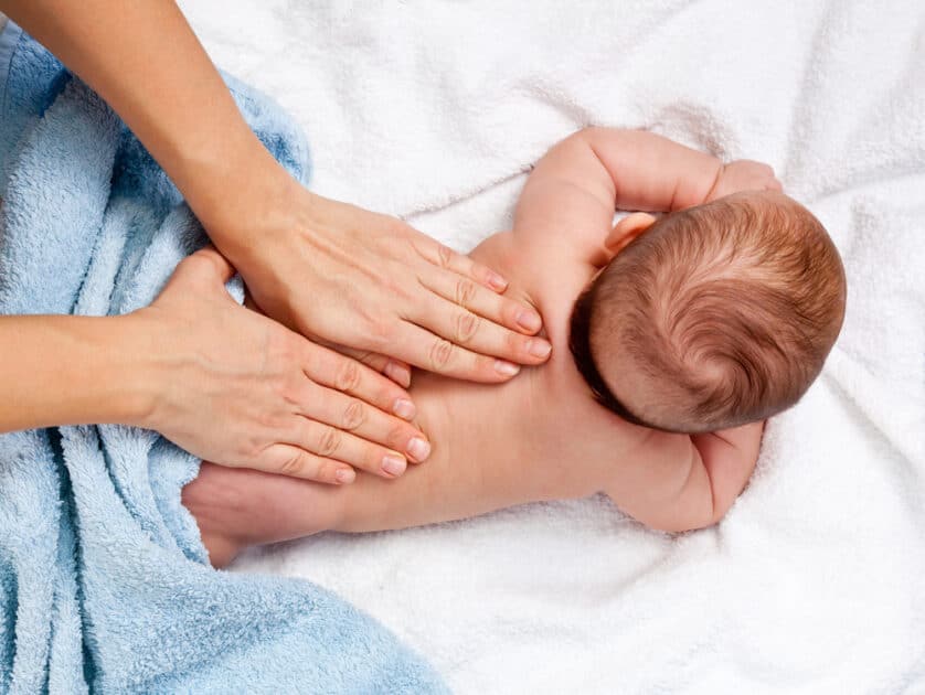 A masseuse works on a 5-month-old baby