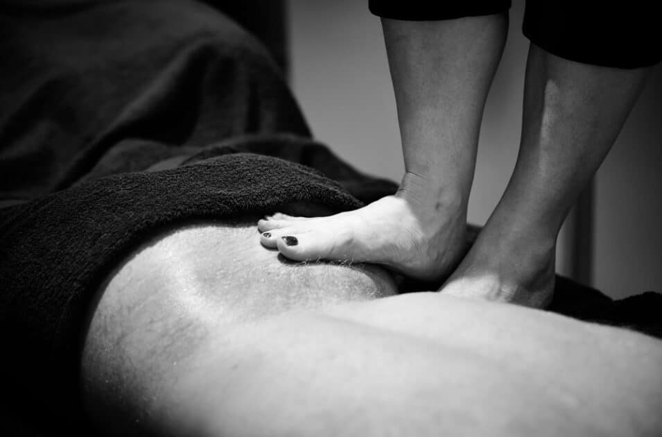 Shots of a massage therapist giving a customer an ashiatsu massage
