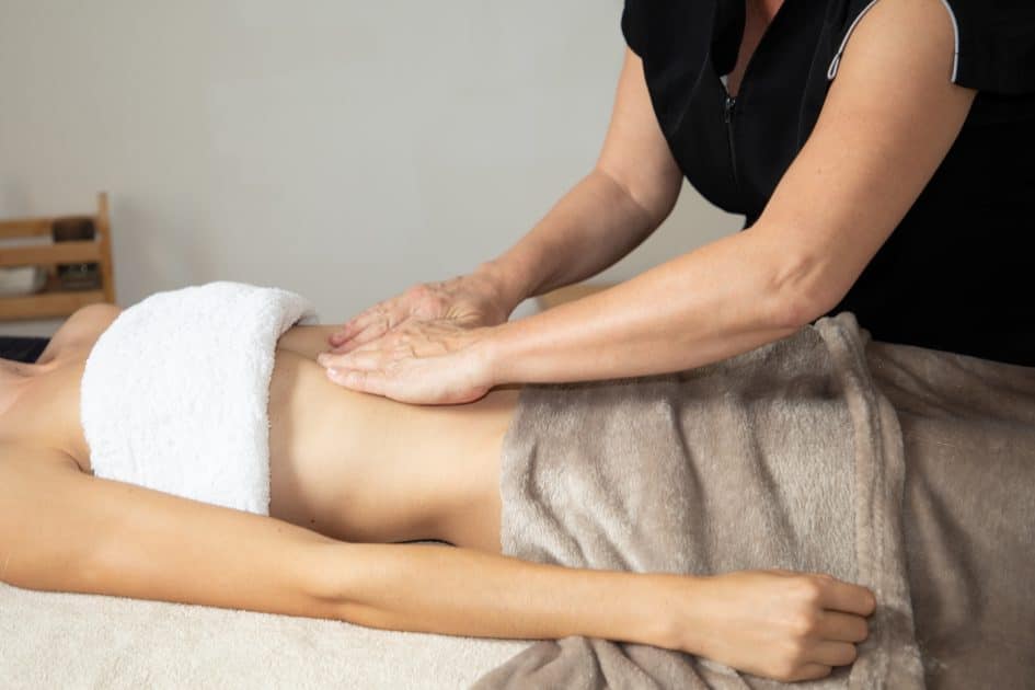 Girl having Manual Ligament Therapy in belly massage