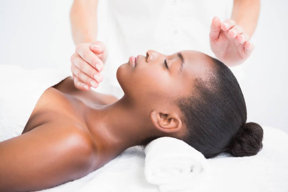 a lady relaxing with reiki massage in a health spa