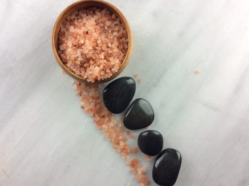Spa hot rocks in a wooden bowl with Himalayan salt
