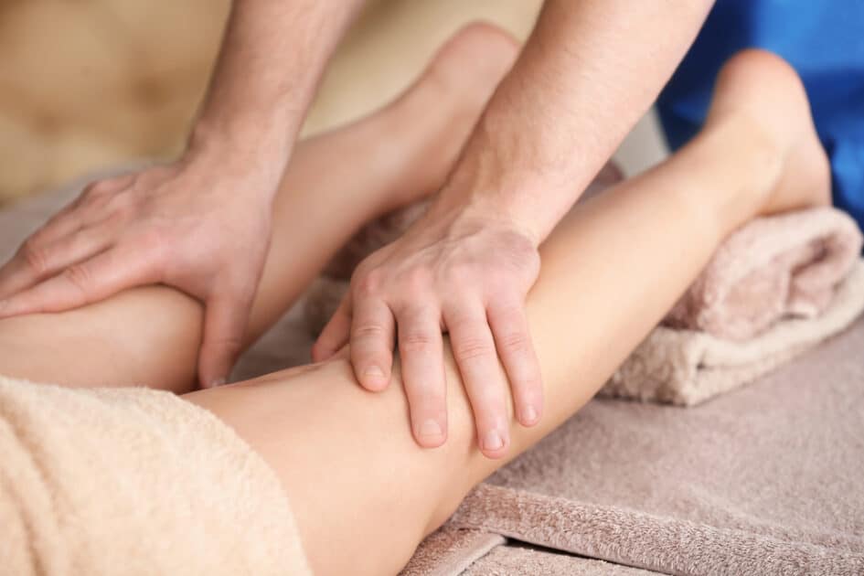 Woman having leg massage in spa