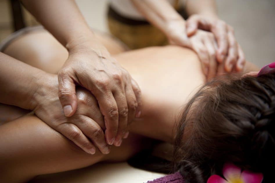 a woman having a four hand massage