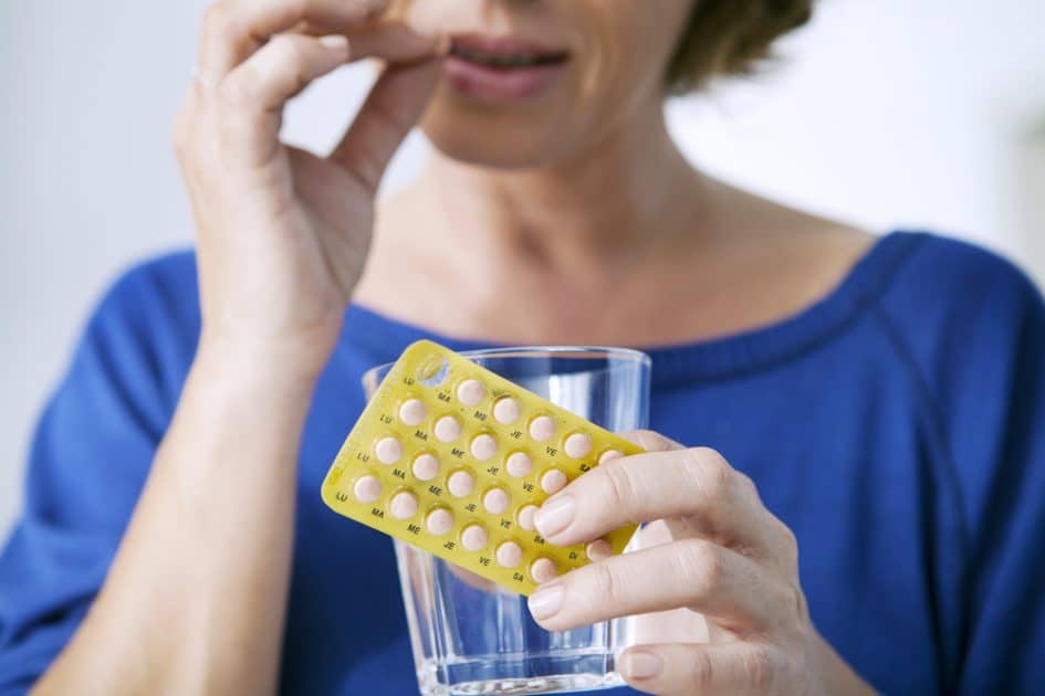 A woman holding medicine, Hormone Replacement Therapy