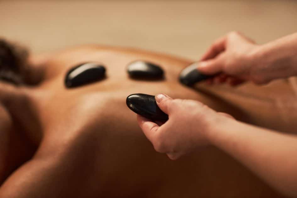 woman receiving hot stone massage.