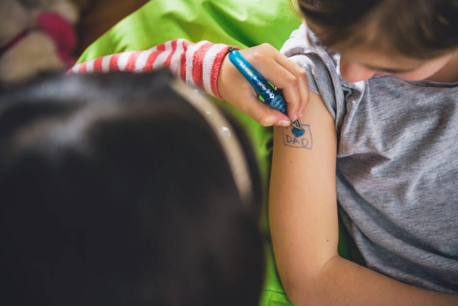 two children playing tattoo pen