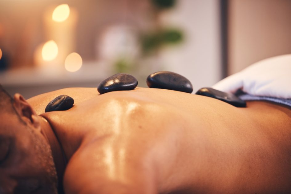 man in spa with hot stone.